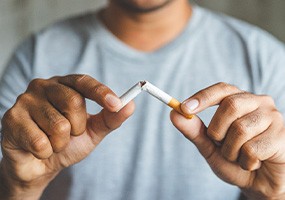 Closeup of patient breaking cigarette