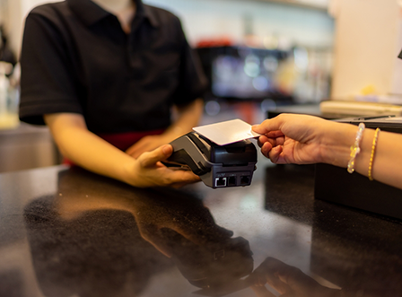 Scanning credit card at front desk of dental office