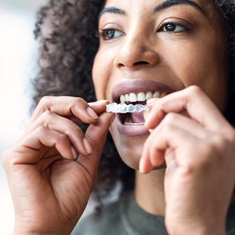 Woman taking off clear aligner