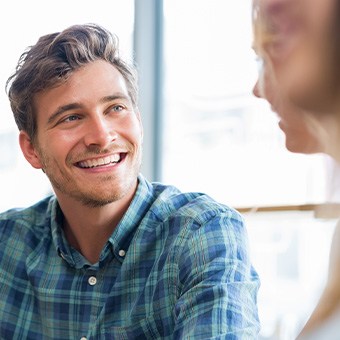 Man in blue shirt smiling with friends