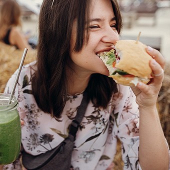 Woman enjoying burger at fair