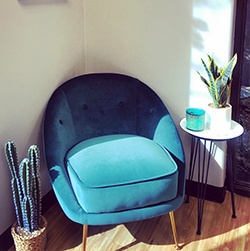 Comfortable blue armchair in waiting room of Austin dental office