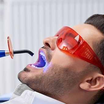 Man receiving cosmetic dental bonding treatment