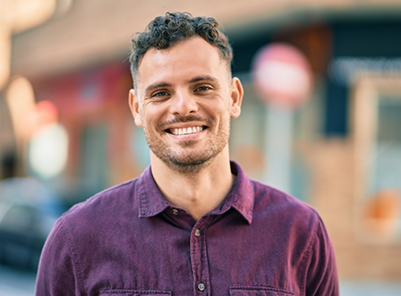 Man in purple shirt smiling