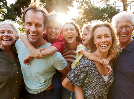Entire family gathered outside smiling