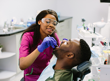 Male patient having teeth examined by emergency dentist in Austin