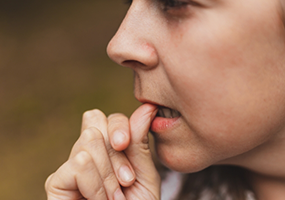 Woman biting her fingernails