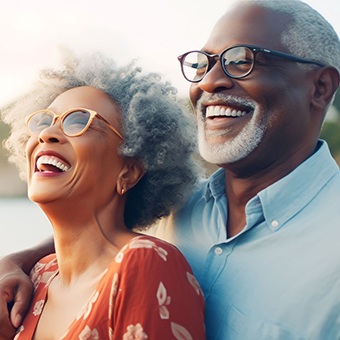 older couple smiling outside near water