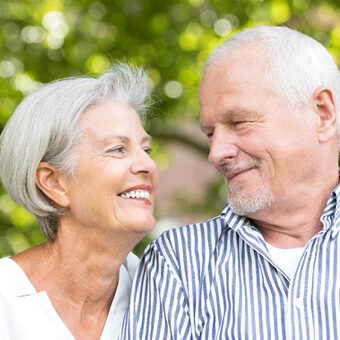 older couple smiling and looking at each other