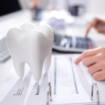 patient calculating cost of dental implants