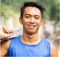 Young man with braces smiling outdoors