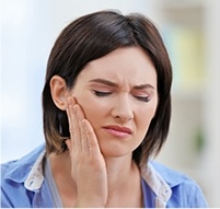 Woman holding the side of her face in pain