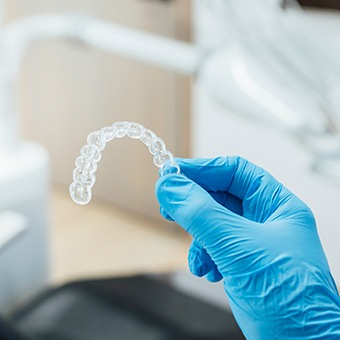 Dentist holding clear aligner