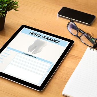 Dental insurance form on tablet on desk