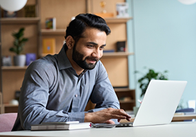 Man typing on laptop
