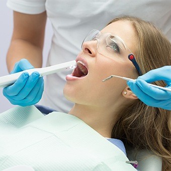Dentist capturing images of a patient's mouth with an intraoral camera